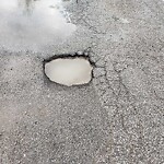 Pothole on Road at 3940 Carmichael Rd